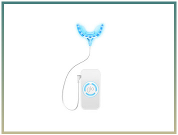 The image displays a blue oral care device, possibly an electric toothbrush or similar dental appliance, with its handle visible and connected to a power source by a cable.