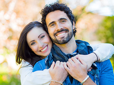 The image shows a man and a woman posing together with smiles, likely for a portrait or personal photograph.